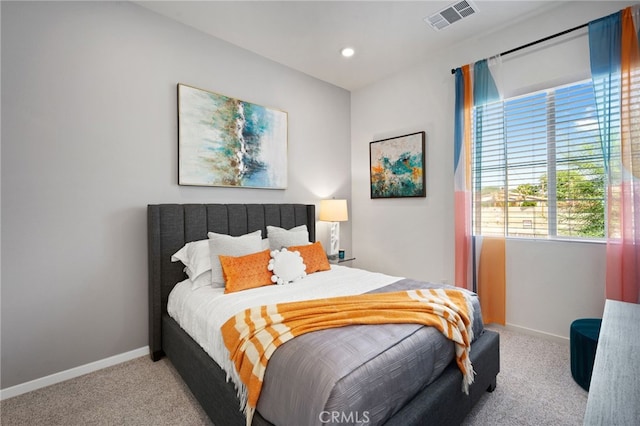 carpeted bedroom featuring recessed lighting, visible vents, and baseboards