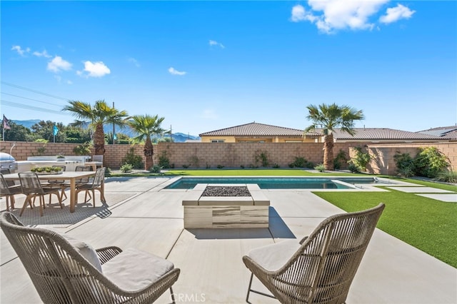 view of patio / terrace featuring a fenced backyard, a fenced in pool, and outdoor dining space