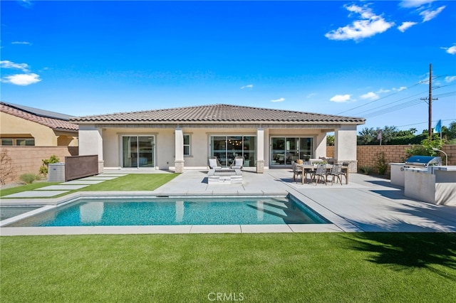 back of house with a yard, fence, area for grilling, and a patio