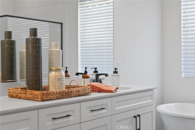 full bathroom featuring double vanity, a soaking tub, and walk in shower