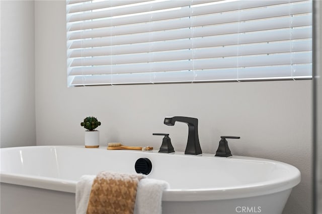 full bathroom featuring a freestanding tub