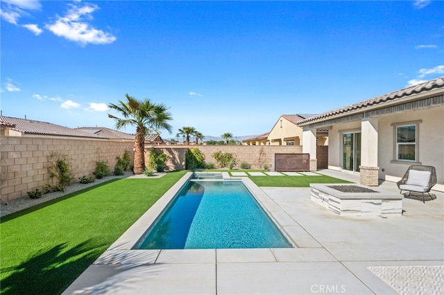 view of swimming pool with a fenced backyard, a fenced in pool, a lawn, and a patio