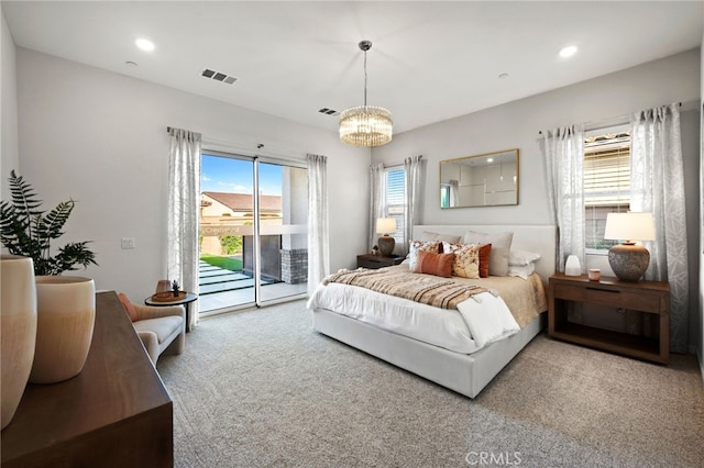 carpeted bedroom featuring access to exterior, recessed lighting, visible vents, and an inviting chandelier