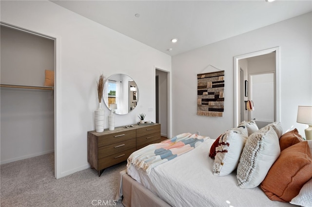 bedroom featuring recessed lighting, a closet, light colored carpet, and baseboards