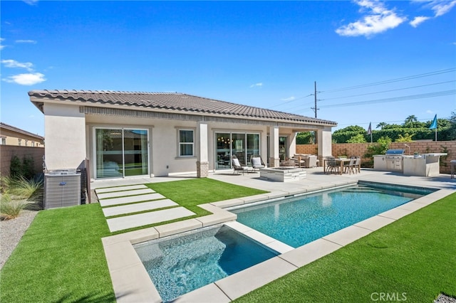 rear view of house with stucco siding, a patio area, fence, and area for grilling