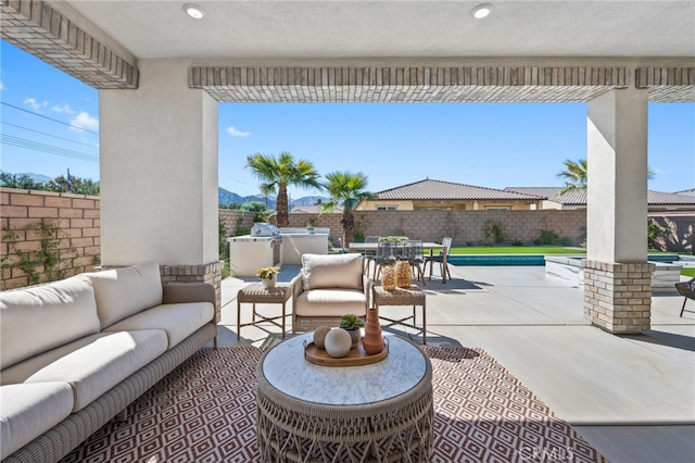 view of patio with outdoor dining area, a fenced backyard, and an outdoor living space