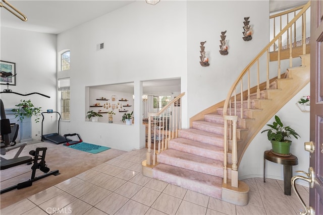 41149 Summitview Ln, Palmdale, CA 93551 - stairway featuring tile patterned flooring, a high ceiling, and carpet floors