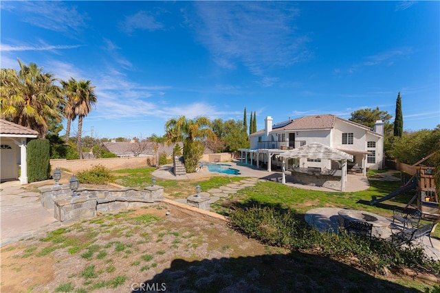 41149 Summitview Ln, Palmdale, CA 93551 - view of yard featuring a fire pit, a patio area, and a playground