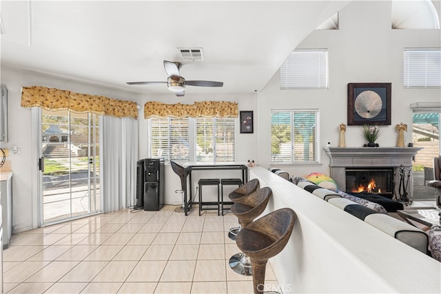 41149 Summitview Ln, Palmdale, CA 93551 - kitchen with light tile patterned floors, ceiling fan, healthy amount of natural light, and a lit fireplace