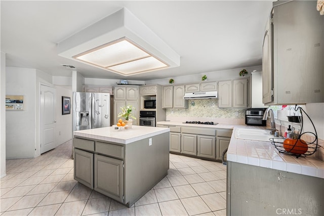 41149 Summitview Ln, Palmdale, CA 93551 - kitchen featuring black appliances, tile counters, under cabinet range hood, gray cabinets, and light tile patterned flooring