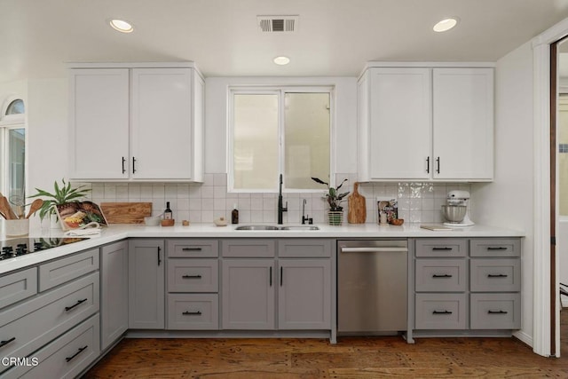 kitchen with a sink, visible vents, dishwasher, and gray cabinetry
