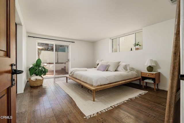 bedroom with visible vents, wood-type flooring, and access to outside