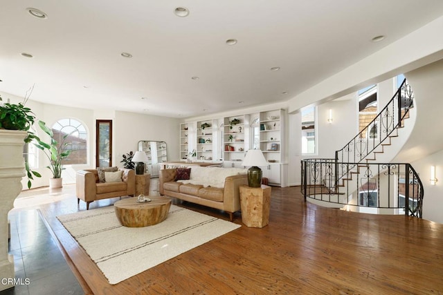 living area featuring built in features, recessed lighting, stairs, and wood finished floors