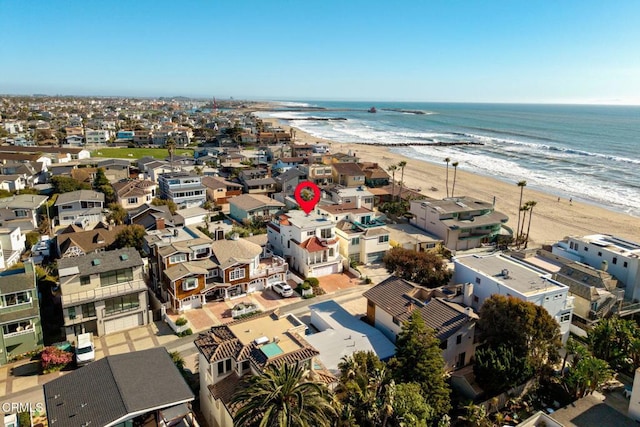 birds eye view of property with a beach view and a water view