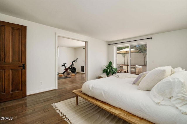 bedroom featuring baseboards and wood finished floors