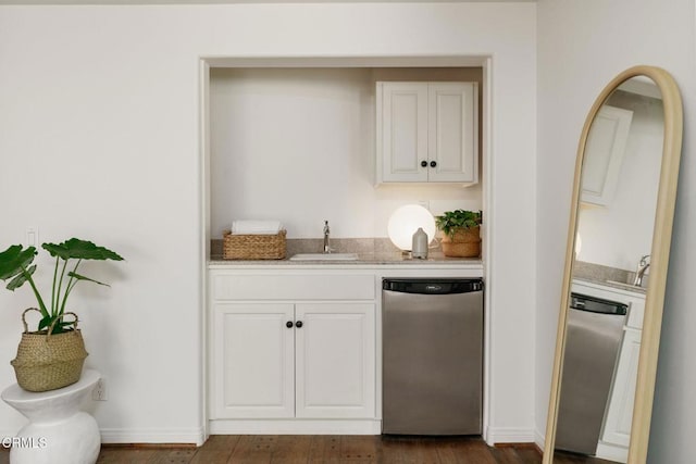 bar featuring dark wood-style floors, dishwasher, indoor wet bar, and a sink