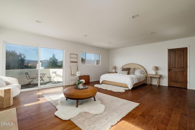 bedroom featuring recessed lighting, baseboards, hardwood / wood-style flooring, and access to outside