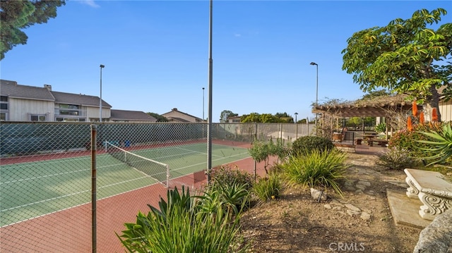 view of tennis court with fence