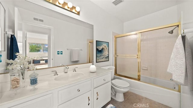 bathroom featuring toilet, vanity, visible vents, and tile patterned floors