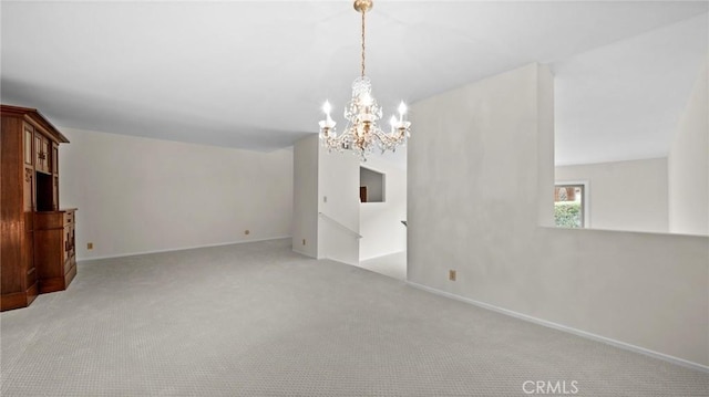 unfurnished living room featuring carpet floors, baseboards, and an inviting chandelier