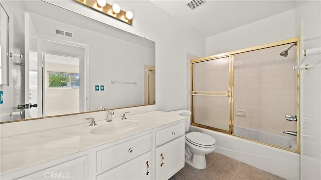 full bath featuring toilet, vanity, visible vents, and tile patterned floors