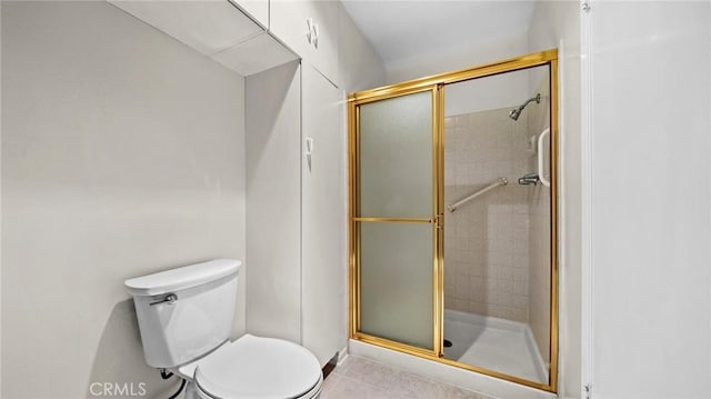 bathroom with a stall shower and toilet