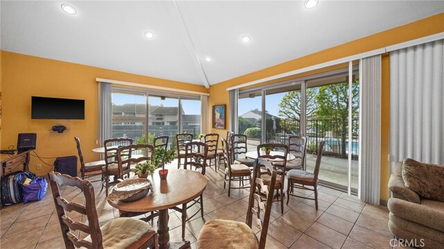 dining room with lofted ceiling, tile patterned floors, and recessed lighting