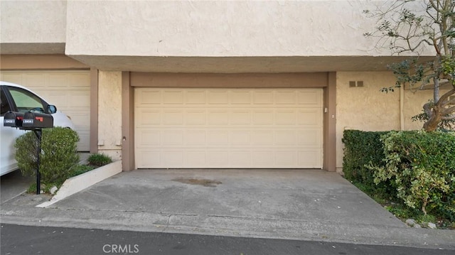 garage featuring driveway