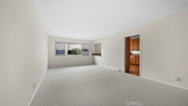 interior space featuring carpet floors and baseboards