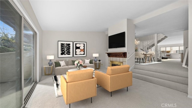 living room with carpet flooring, a fireplace, and an inviting chandelier