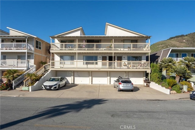 view of property with a garage and driveway