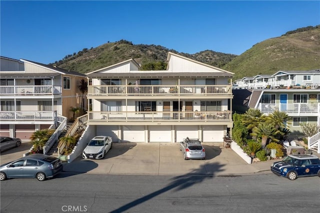 view of front facade with a garage, driveway, and a mountain view