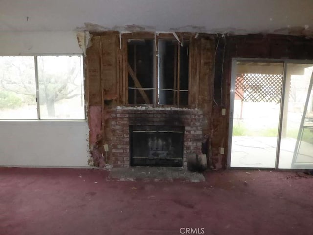 unfurnished living room with a brick fireplace