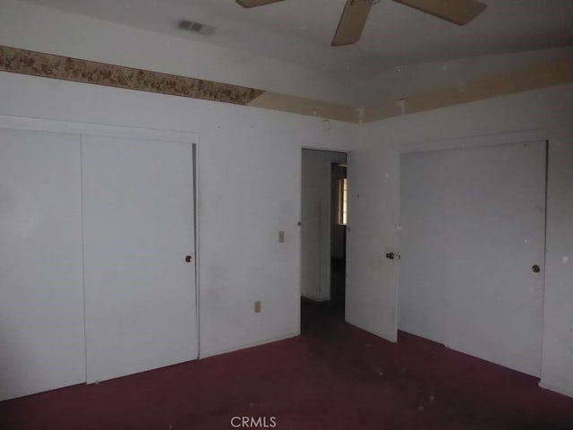 unfurnished bedroom with ceiling fan, a closet, and visible vents