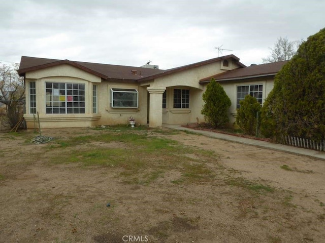 single story home featuring stucco siding