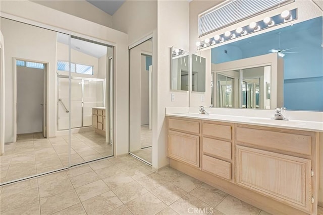 full bathroom featuring a ceiling fan, tile patterned floors, a sink, and double vanity