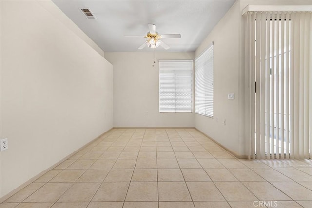 unfurnished room featuring a ceiling fan, visible vents, and light tile patterned floors