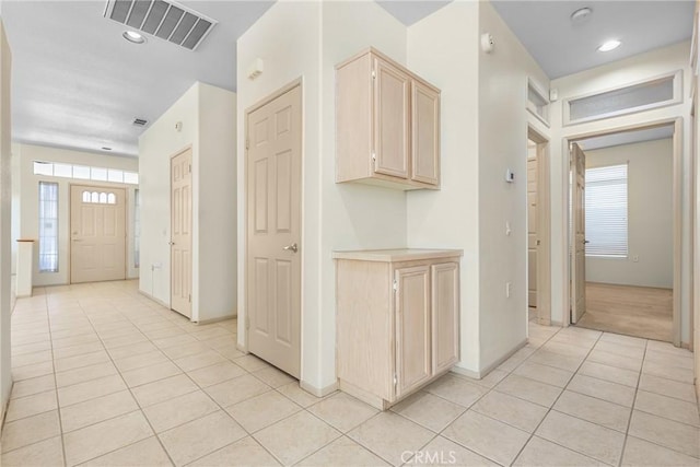 hall featuring light tile patterned floors, baseboards, visible vents, and recessed lighting