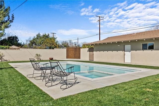 view of pool with an in ground hot tub, fence, a lawn, and a patio