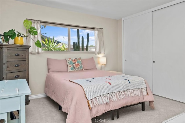 bedroom featuring baseboards, a closet, and carpet floors