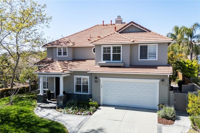 view of front facade featuring driveway, a garage, a tile roof, a chimney, and fence