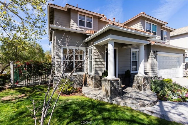 rear view of property with driveway, a lawn, and fence