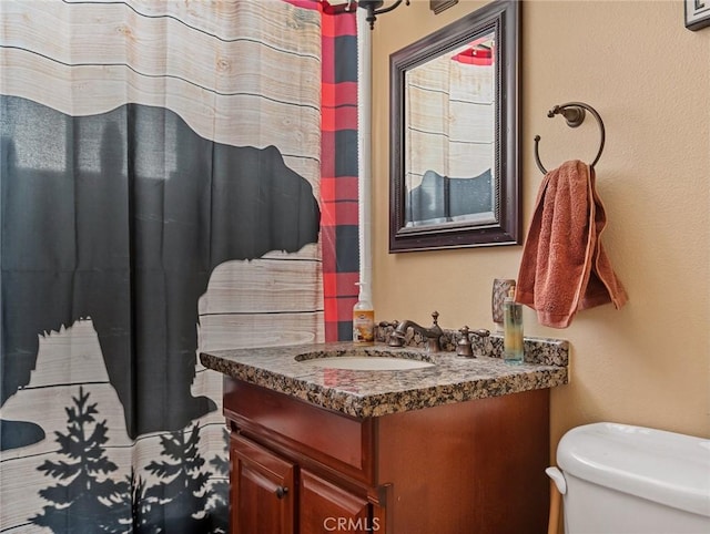 full bathroom featuring toilet and vanity