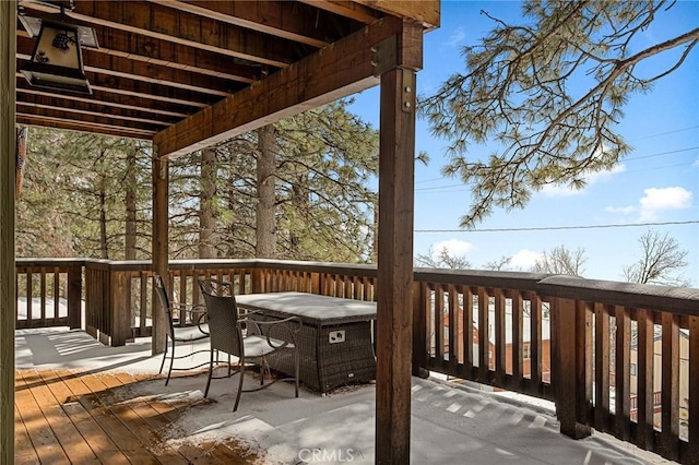 wooden terrace featuring outdoor dining area