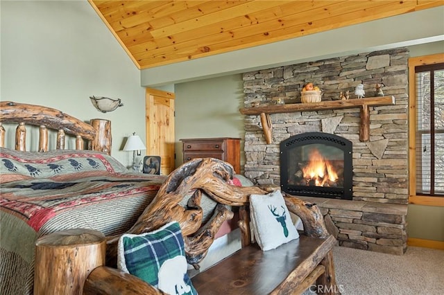 carpeted bedroom featuring lofted ceiling, a stone fireplace, and wood ceiling