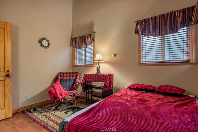 bedroom featuring wood finished floors and baseboards