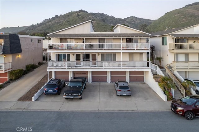 townhome / multi-family property with concrete driveway and a mountain view