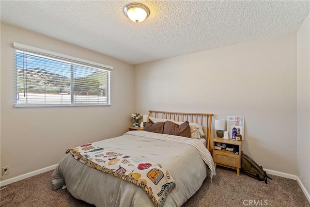 bedroom with carpet floors, a textured ceiling, and baseboards