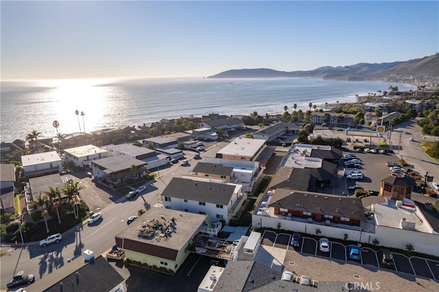 drone / aerial view featuring a water and mountain view