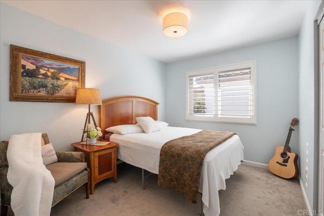 carpeted bedroom featuring baseboards